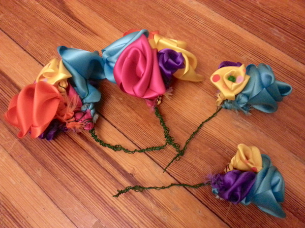little ribbon flowers on green wire stems, laid out on the floor