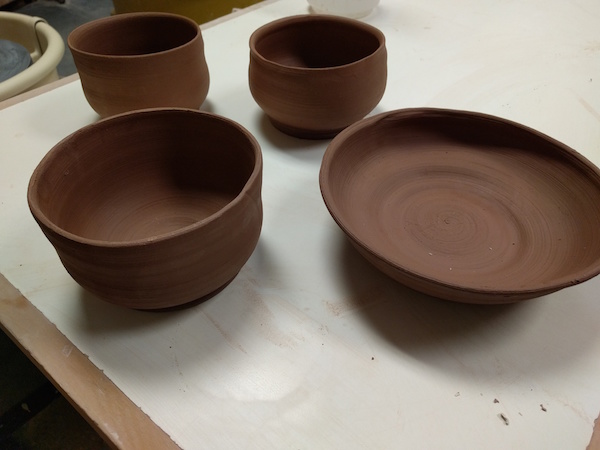 four brown clay bowls