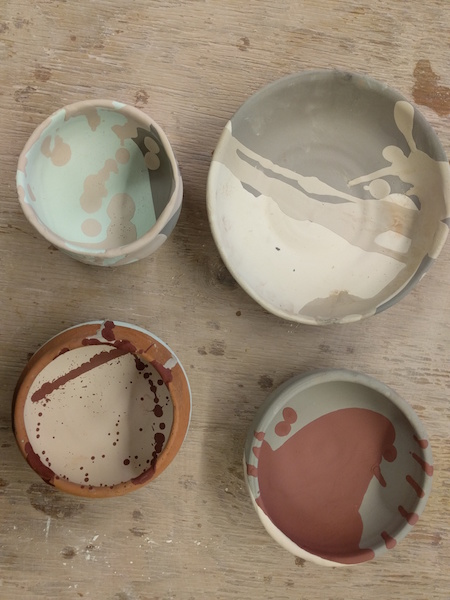 four glazed, unfired bowls