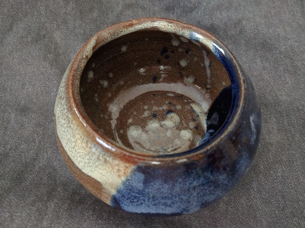 bowl with an opening smaller at the top, brown and blue glazes with white spots