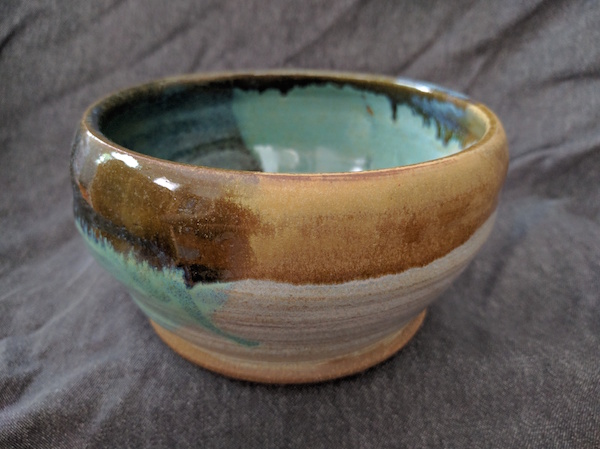 side view of a bowl, white and green and yellow