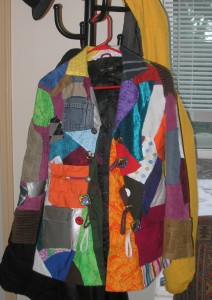 front of a very colorful patchwork coat