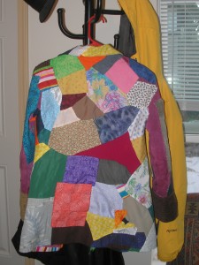 the back of a very colorful patchwork coat