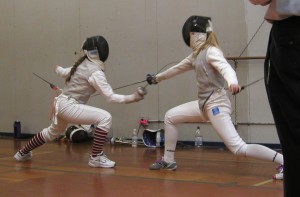 Me lunging on the strip, foil bent as I hit my opponent.