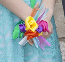 colorful satin ribbon flowers in a corsage on a woman's wrist