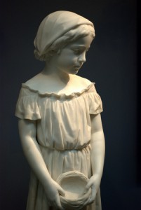 _statue of a young girl holding a nest_