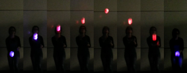 Glorb acceleration series of images of person tossing a glowing ball in an arc, on the left it is blue, then it turns red, then back to blue, reflecting the ball's acceleration
