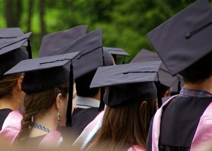 VC graduation (Credit: Terry Bolstad) backs of students heads, wearing black motorboard hats and tassels - photo by Terry Bolstad