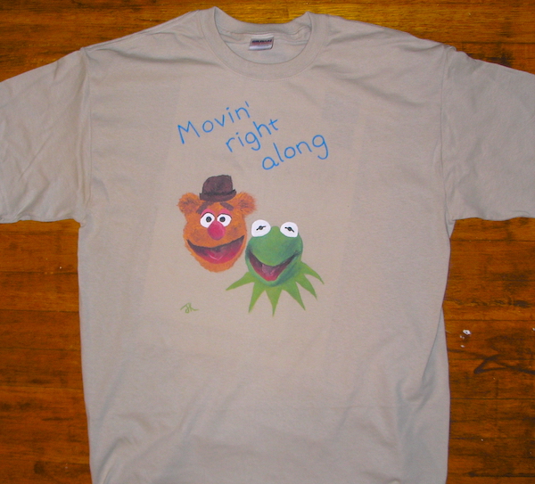 t-shirt with text movin' right along and painted pictures of fozzie bear and kermit the frog